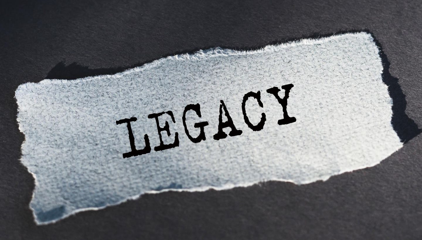 Legacy text, inscription, phrase is written on a torn paper that lies on a table. Legacy text, inscription, phrase is written on a torn paper that lies on a table.