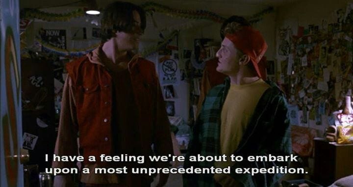 This may contain: two young men standing next to each other in a room with posters on the wall