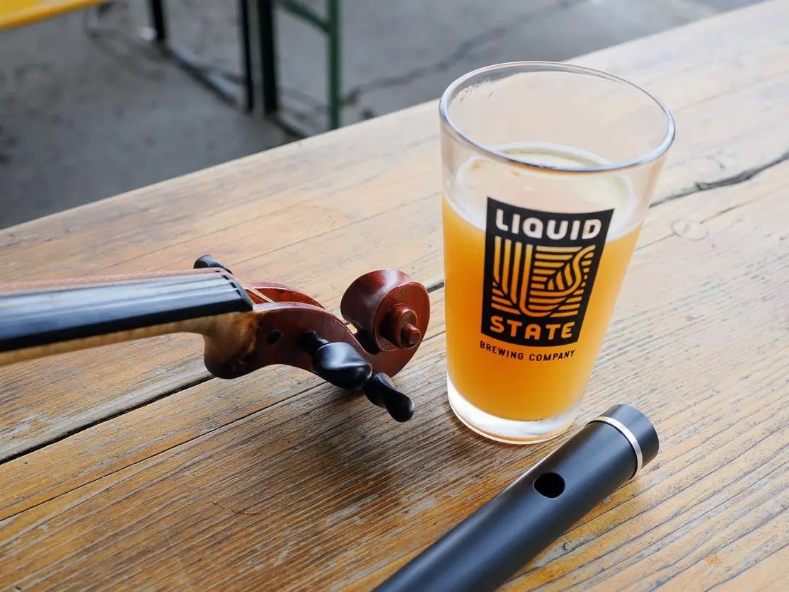 May be an image of ‎clarinet, violin, drink, flute and ‎text that says '‎LIQUID আ।. الرل STATE BREWING BREWING WING COMPANY M BRE‎'‎‎
