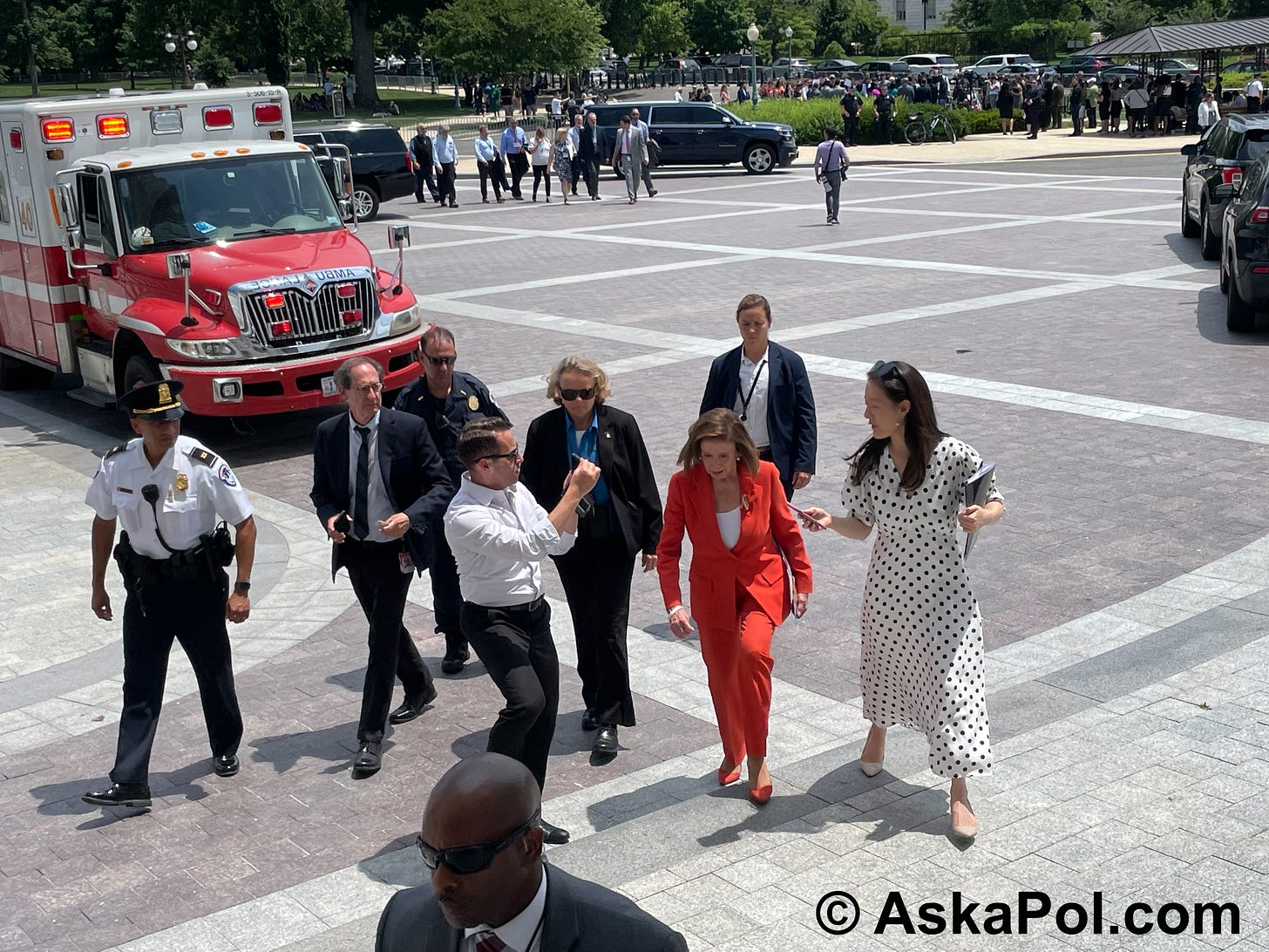 Police officers walk with Speaker Emeria Nancy Pelosi back to the Capitol, as a large ambulance parks on the US Capitol grounds in back of them © www.askapolpolitics.com Police officers walk with Speaker Emeria Nancy Pelosi back to the Capitol, as a large ambulance parks on the US Capitol grounds in back of them © www.askapolpolitics.com