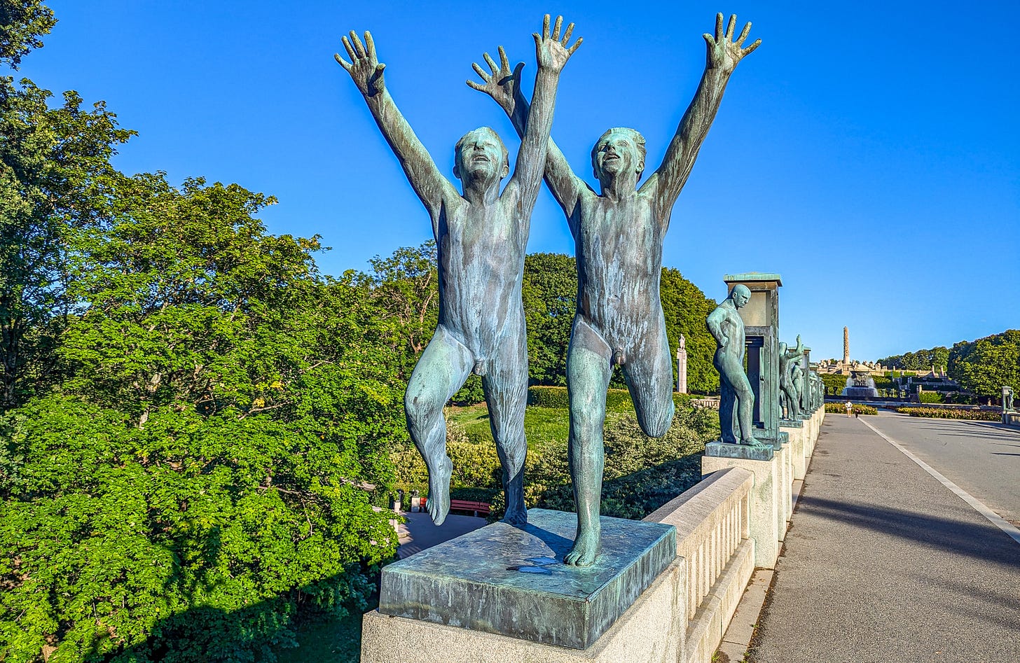 Bronze sculplture located on the bridge of two boys running, their hands in the air. 