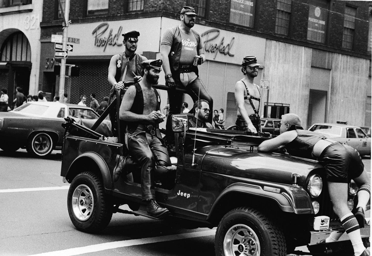 A group of men dressed in leather fetish clothing ride in a truck at the intersection of 32nd Street and Fifth Avenue...