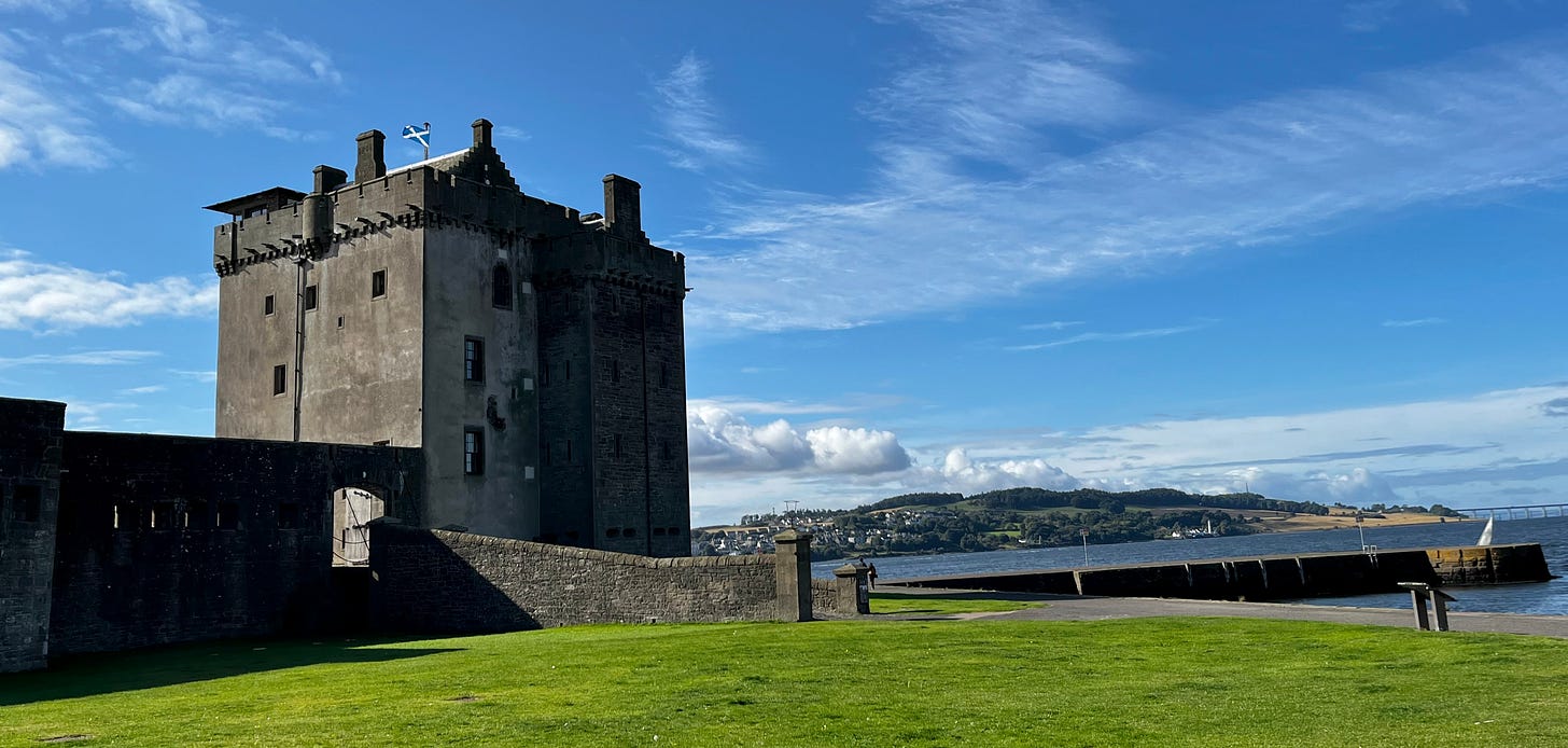 square castle tower, road bridge across the firth in the background