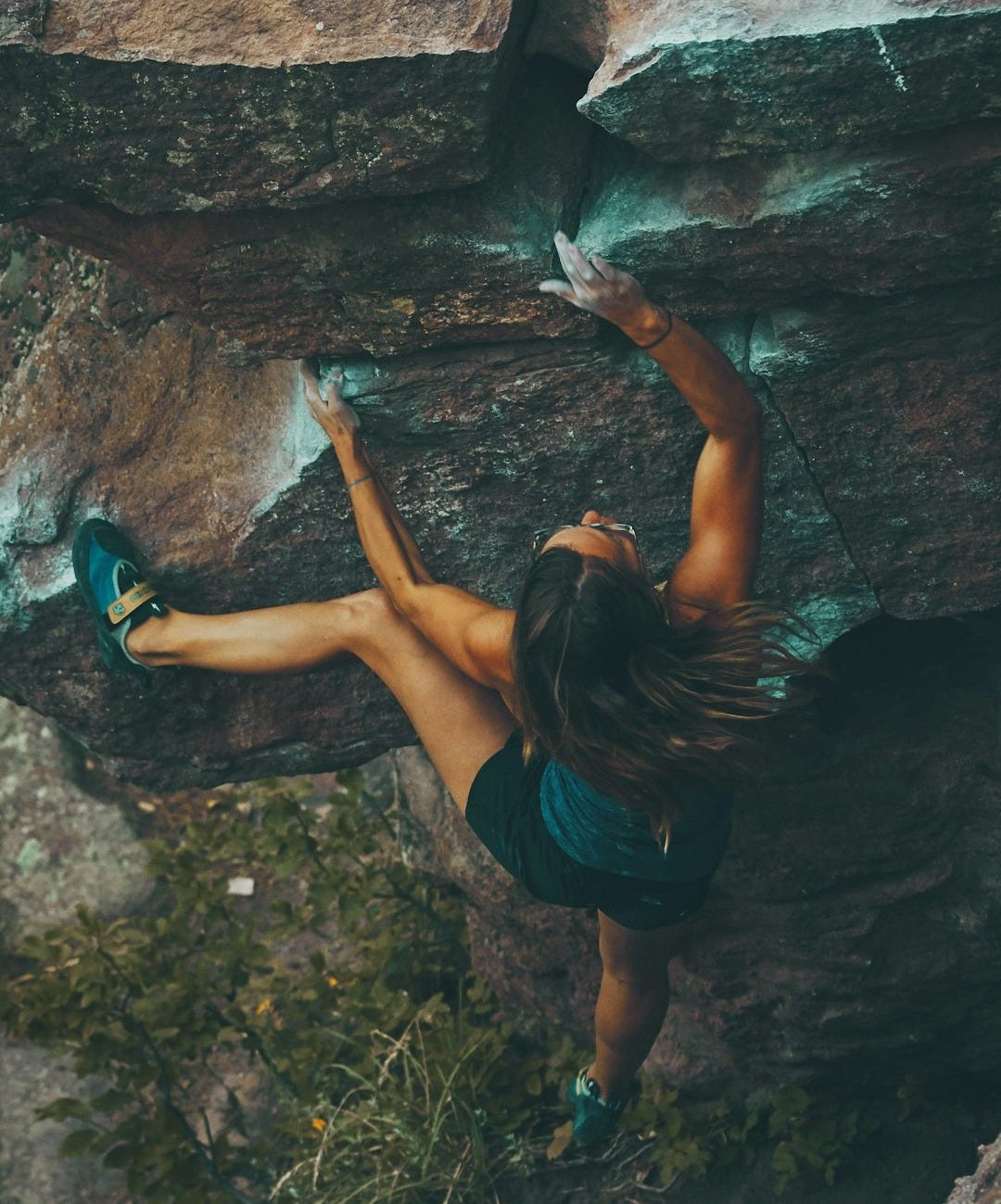 photo of woman climbing mountain