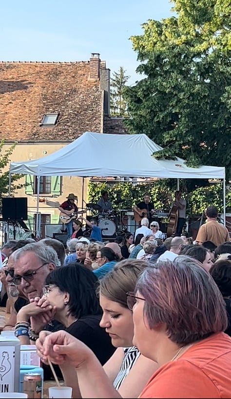 Snapshots of a small French village (Flagy) on a summer evening. A picnic basket, a lady making french fries, a beautiful small stone home, and musicians on stage