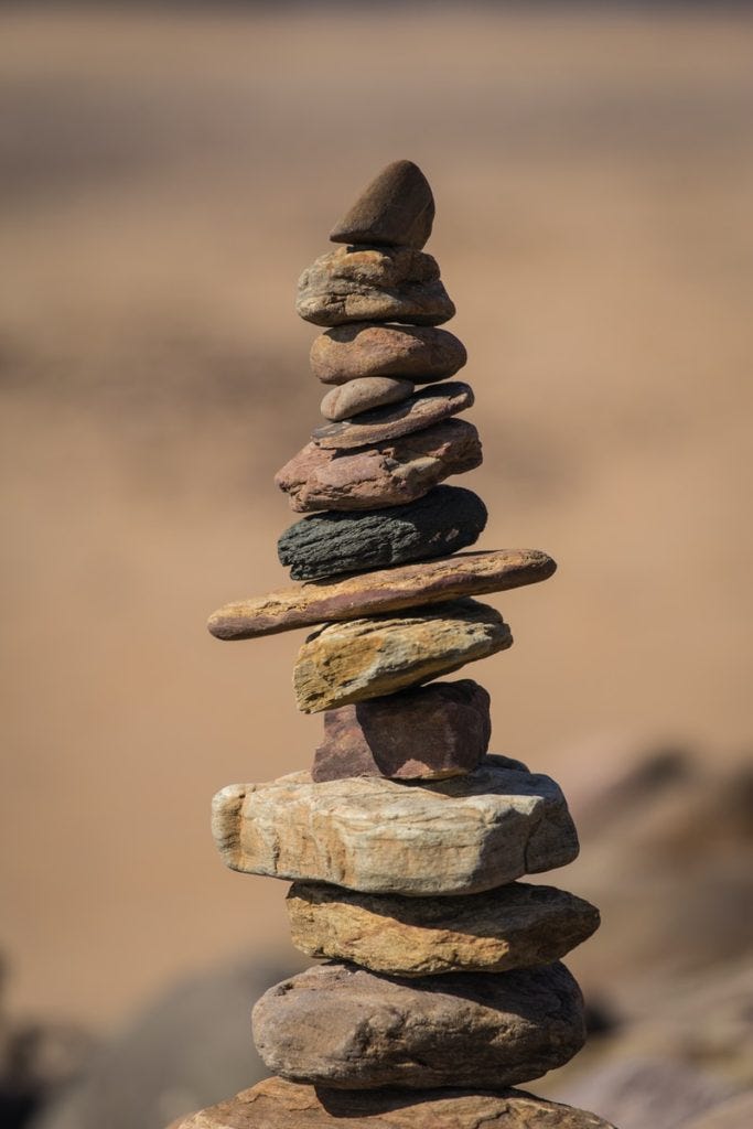 selective focus photography of balance stones selective focus photography of balance stones