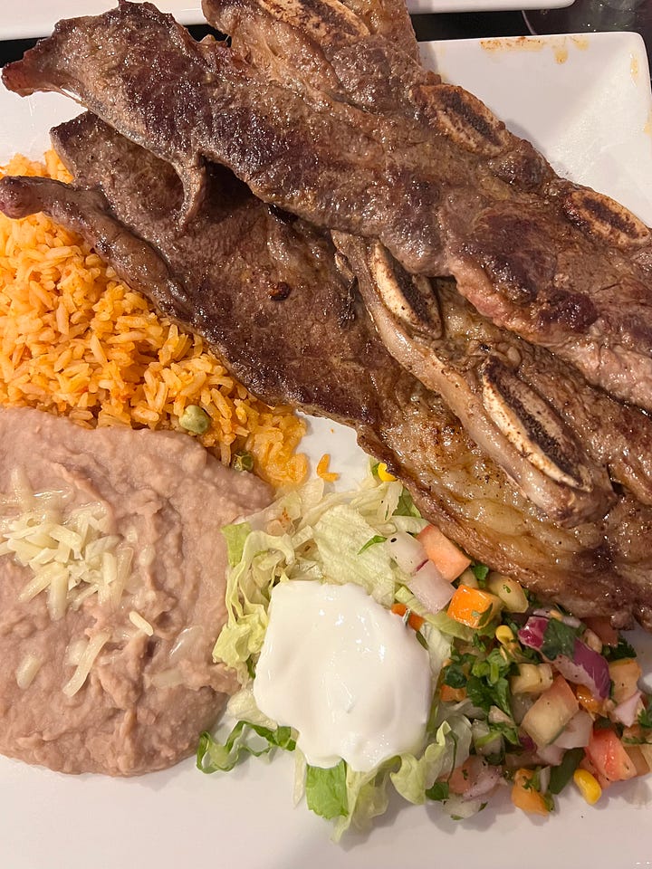 Costello de res asada with grilled jalapeños Grilled cross cut ribs Mexican rice refried beans with pico de gallo sour cream lettuce and two grilled jalapeños