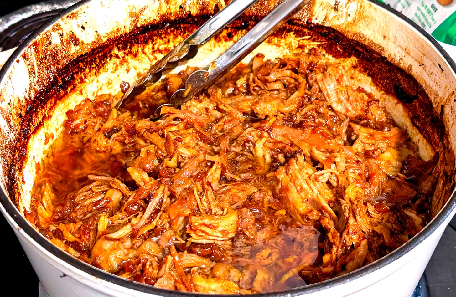 The pork after cooking for three hours and being mercilessly shredded by tongs. The pork after cooking for three hours and being mercilessly shredded by tongs.