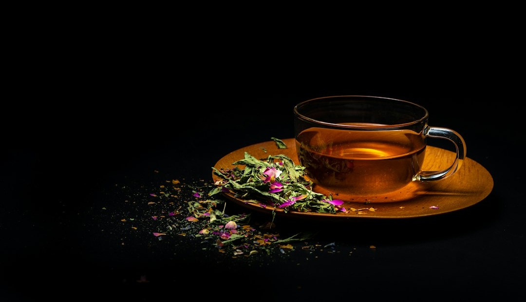 clear glass teacup on saucer