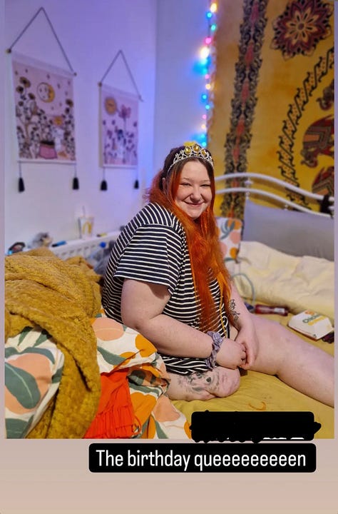 photo 1: A person seated in a wheelchair, smiling and holding up an iPad showing their career journey. They’re in a cosy room with yellow walls, autumn leaf decorations, and plants in the background.  photo 2: A mirror selfie in a hotel room. The person is wearing a bright orange jumpsuit with chain accessories, long orange hair, and giving a peace sign while seated in a wheelchair.  photo 3: A person sitting on a bed wearing a striped dress and a decorative tiara, smiling warmly. The room has colourful bedding, wall hangings, and soft string lights.  photo 4: A person in a wheelchair reaching through a fence to pet a Highland cow in a field. The scene is outdoors with fallen autumn leaves and trees with golden foliage.  photo 5: A mirror selfie taken in an accessible bathroom. The person is wearing sunflower-patterned clothing and a bright yellow top, smiling while seated in a wheelchair.