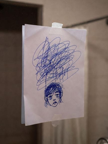 A chaotic blue scribble exploding from a tired, half-drawn face on a note taped to a bathroom mirror – the exact doodle your Life leaves when it’s finally had enough of being ignored