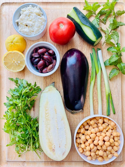 Mediterranean Nachos ingredients, shredded cucumber, roasted eggplant.