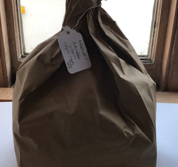Images of brown bags containing dried herbs with handwritten labels