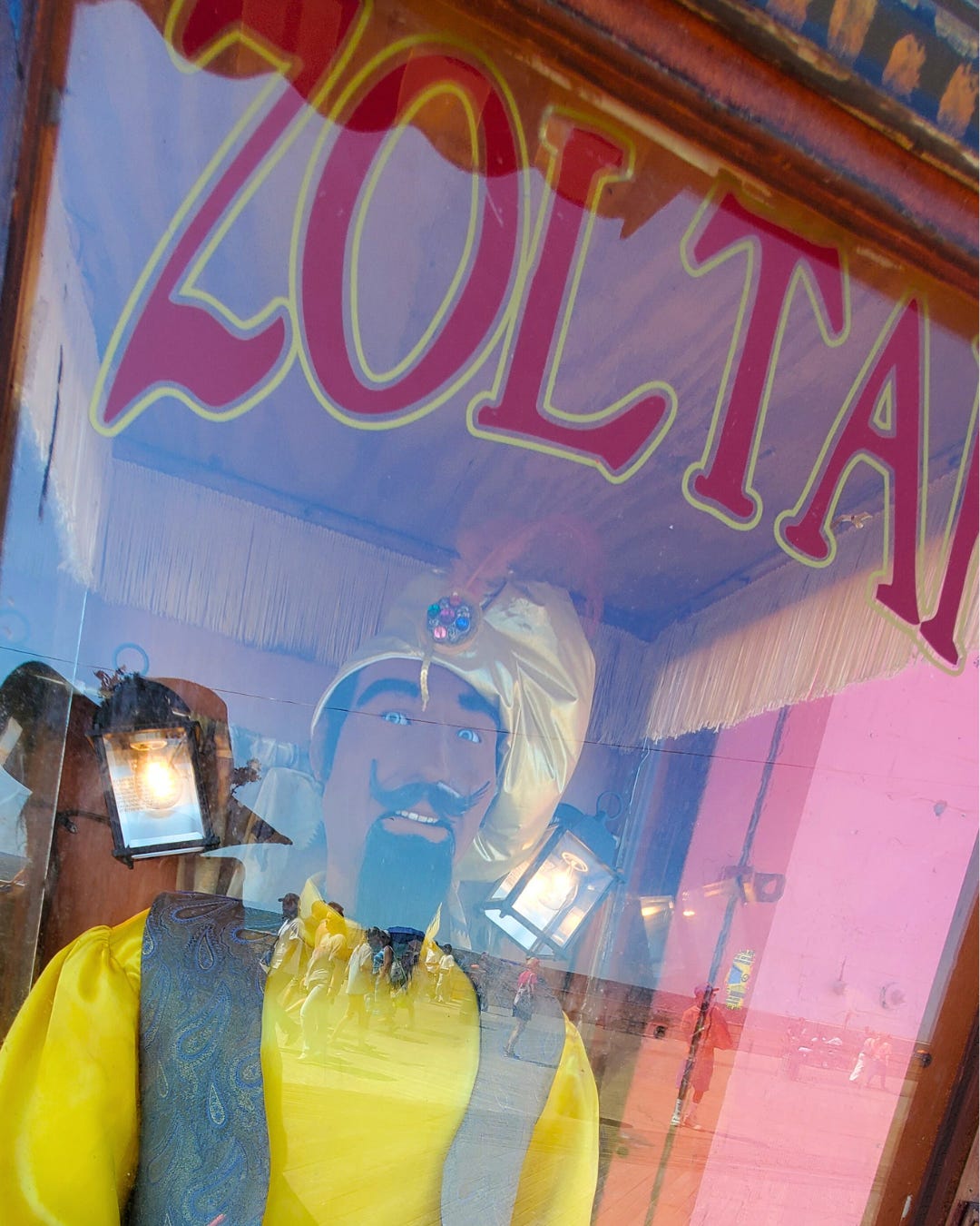 The perilous stare of Zoltar's painted blue eyes bores out from behind a glass emblazoned with the miniature mage's name. He is bedecked in sunny yellow and his teeth are bared, awaiting conjuration.