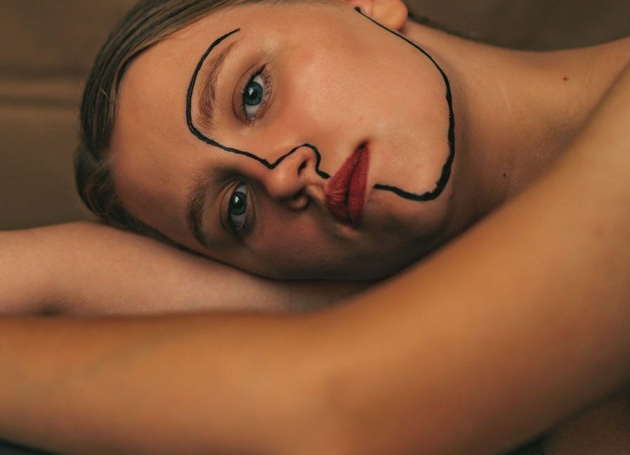 a woman with a face painted on her head