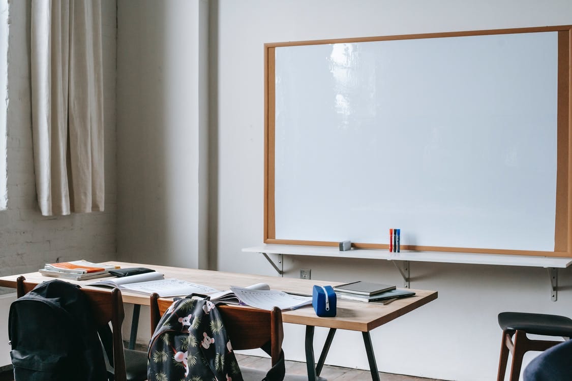 Free School bench with stationery in classroom Stock Photo