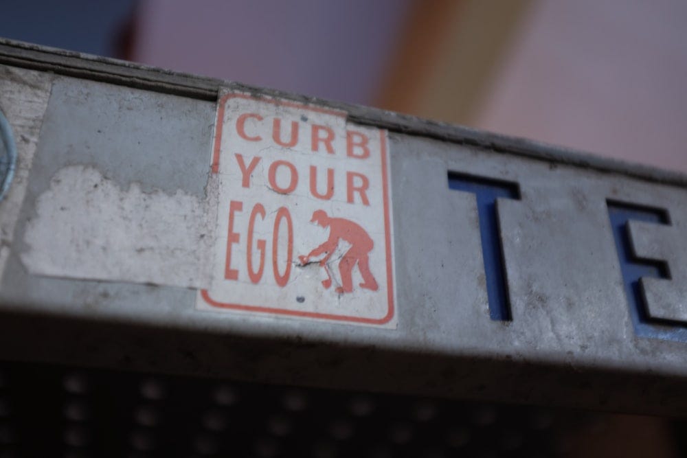 Sticker says curb your ego, but dont forget your organizational ego Sticker says curb your ego, but dont forget your organizational ego