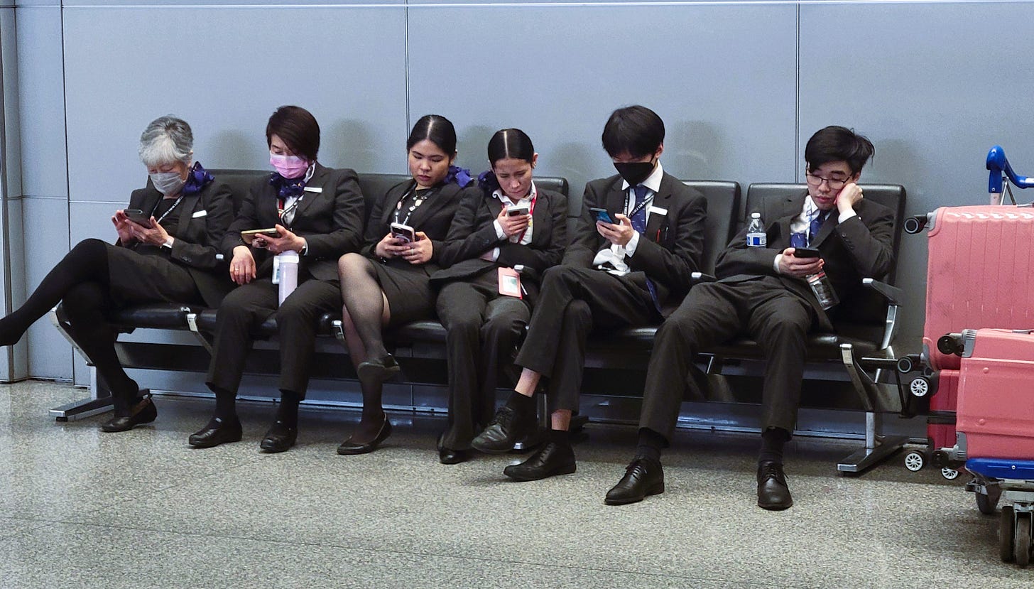 Airplane crew looking at their phones
