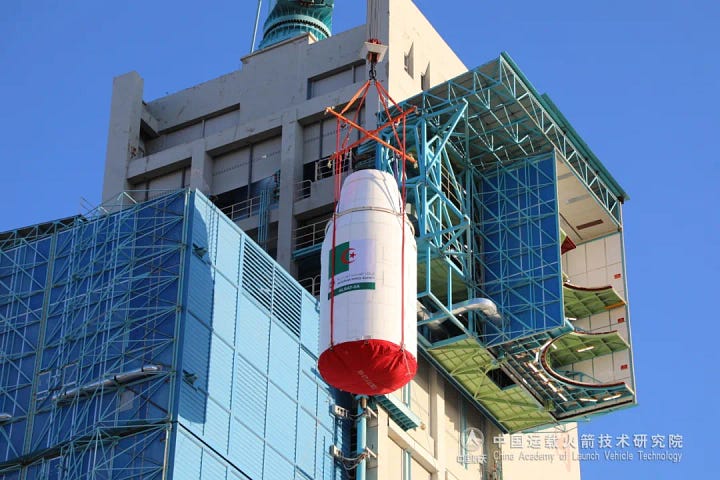 The Long March 2C's fairing, sporting the Algerian flag, encapsulating AlSat-3A and being placed atop of the launch vehicle.