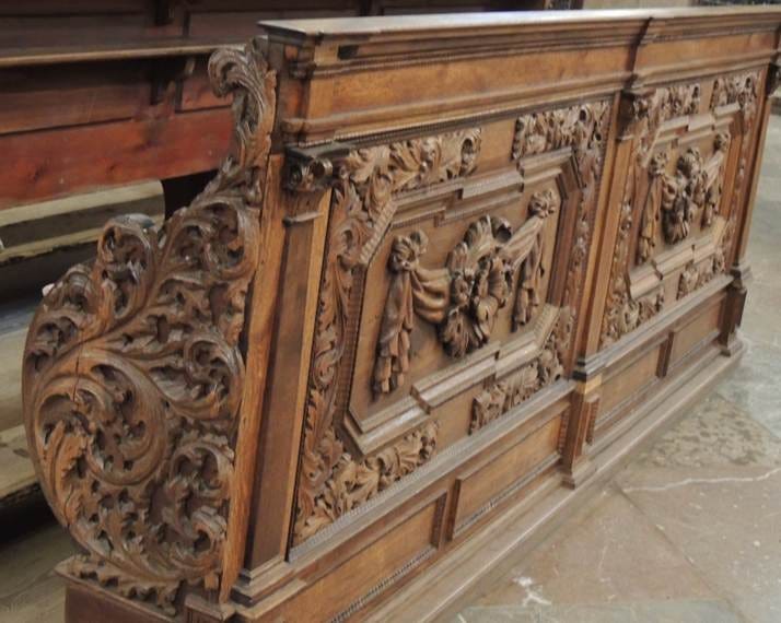 A wooden bench with carved designs

AI-generated content may be incorrect.