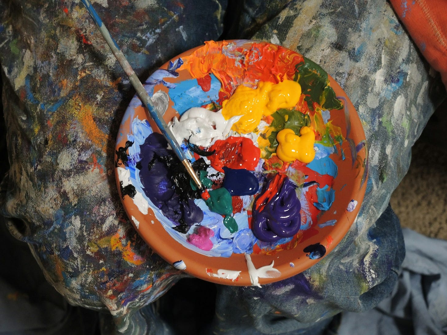 Paints on a tray, some of them mixing together Paints on a tray, some of them mixing together