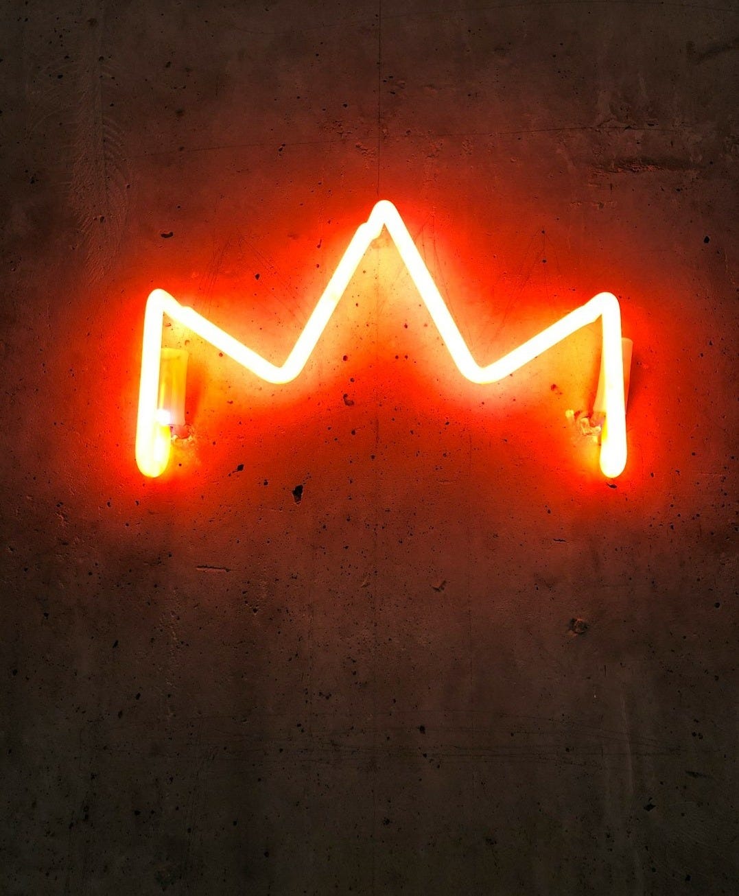 a neon sign that is on the side of a wall a neon sign that is on the side of a wall