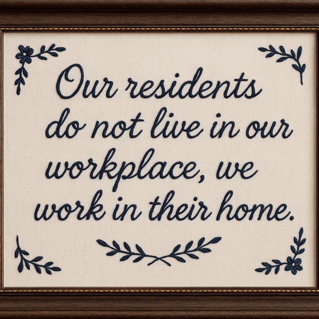 Framed embroidered placard for nursing home entranceway with prominent quote.