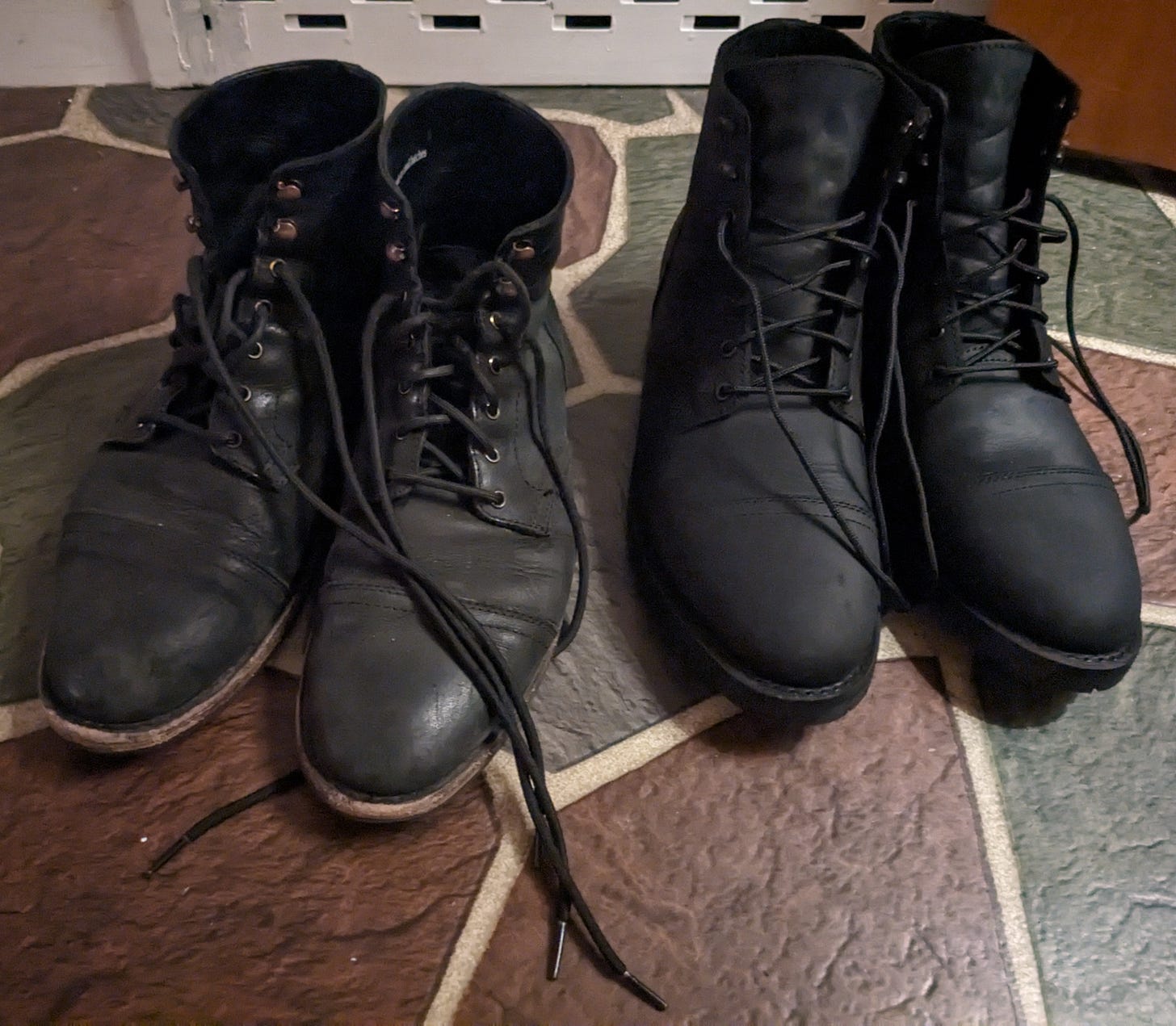 Two pairs of black boots placed side by side.