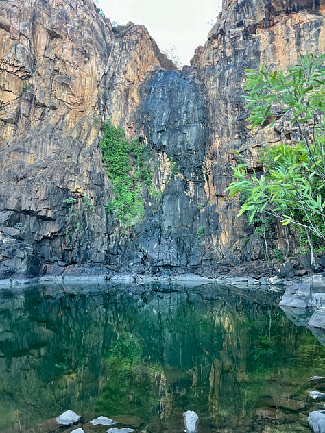Three beautiful images of the Northern Territory. A rocky watering hole, a dramatic gorge. and the last glowing purple light of a sunset.