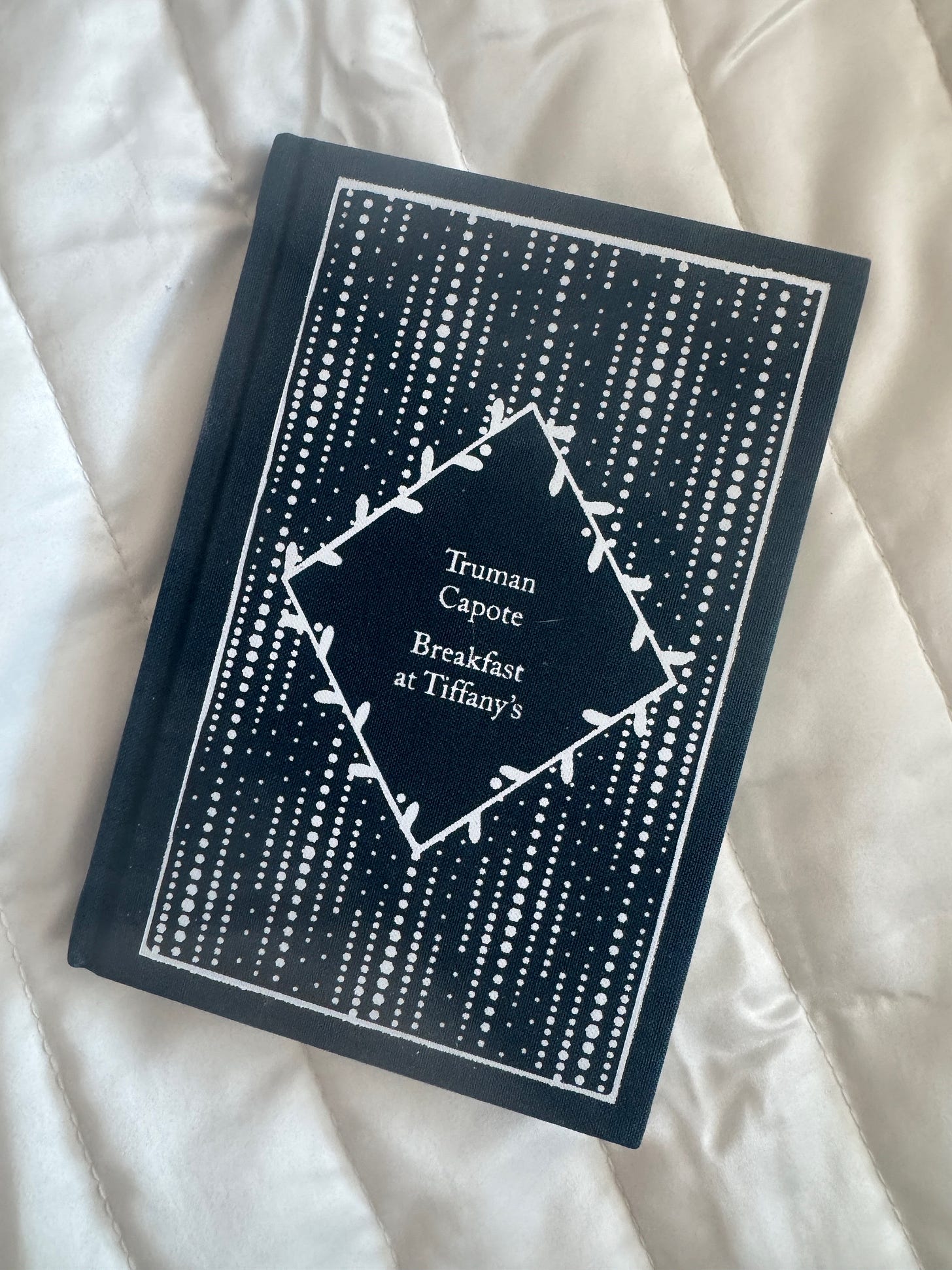 a dark blue cloth bound edition of Truman Capote's Breakfast at Tiffany's a dark blue cloth bound edition of Truman Capote's Breakfast at Tiffany's