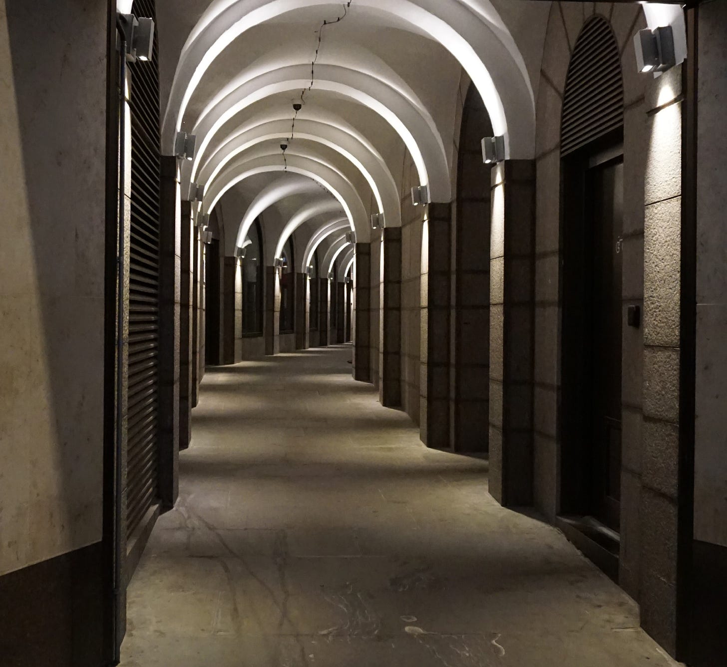 Image is of a multi-domed passageway that curves and connects one street to another. Image is of a multi-domed passageway that curves and connects one street to another.