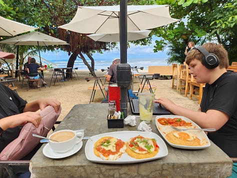 6 images of two boys homeschooling from different places, including an RV and on the beach