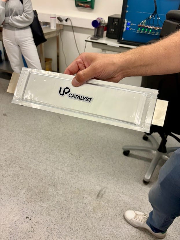 A hand holding a white package
Description automatically generated