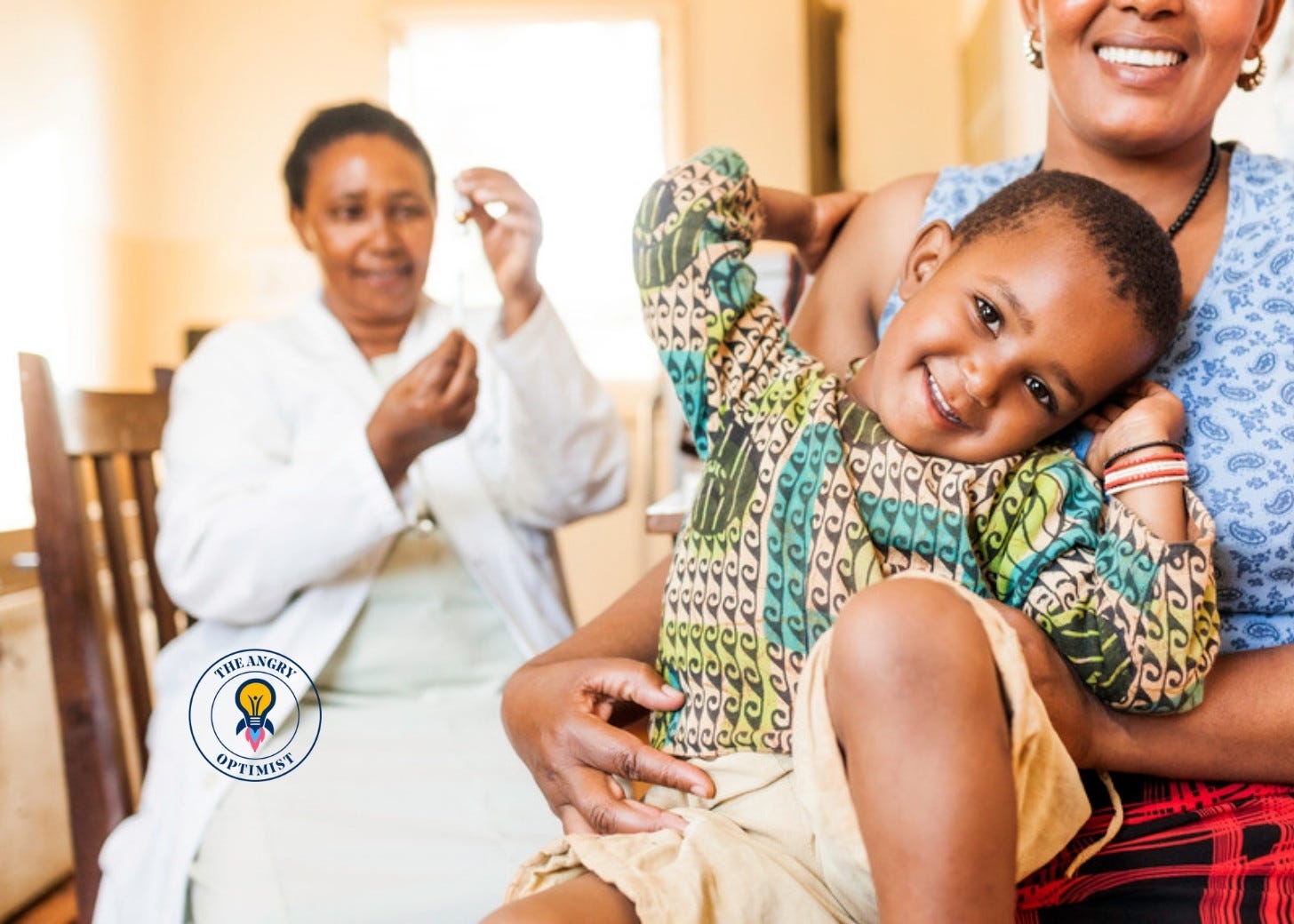 A nurse prepares a vaccine syringe while a smiling child sits on a woman's lap A nurse prepares a vaccine syringe while a smiling child sits on a woman's lap