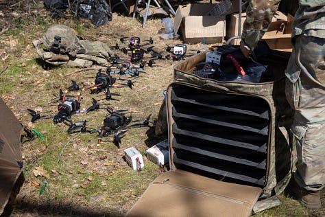 U.S. Army soldiers training with Titan V3 counter-unmanned aerial system technology in a wooded Latvian environment during the multinational Saber Strike 26 exercise.