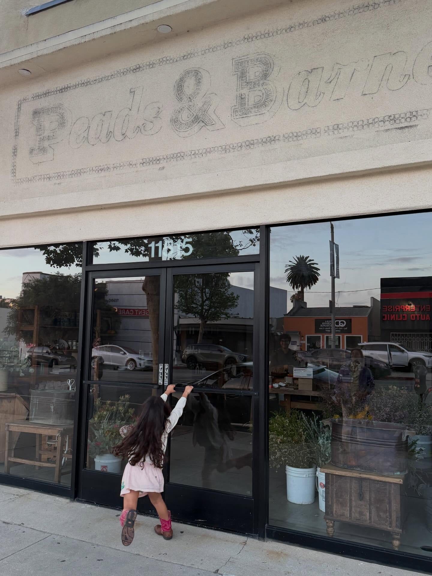 A child claws at the entrance of Good Things