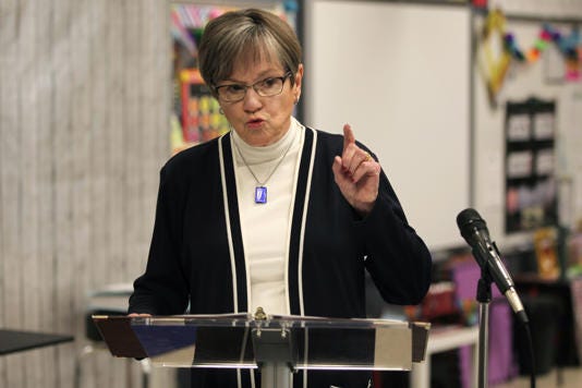 Kansas Gov. Laura Kelly speaks to reporters during a news conference, Monday, April 24, 2023, in a second-grade classroom at Elmont Elementary School in Topeka, Kansas. Kelly has allowed a bill that bars state and local officials from using environmental, social and governance factors in investing public funds or awarding contracts to become law without her signature. (AP Photo/John Hanna)