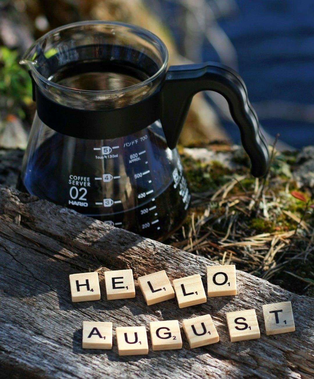a coffee pot with scrabbles spelling hello august