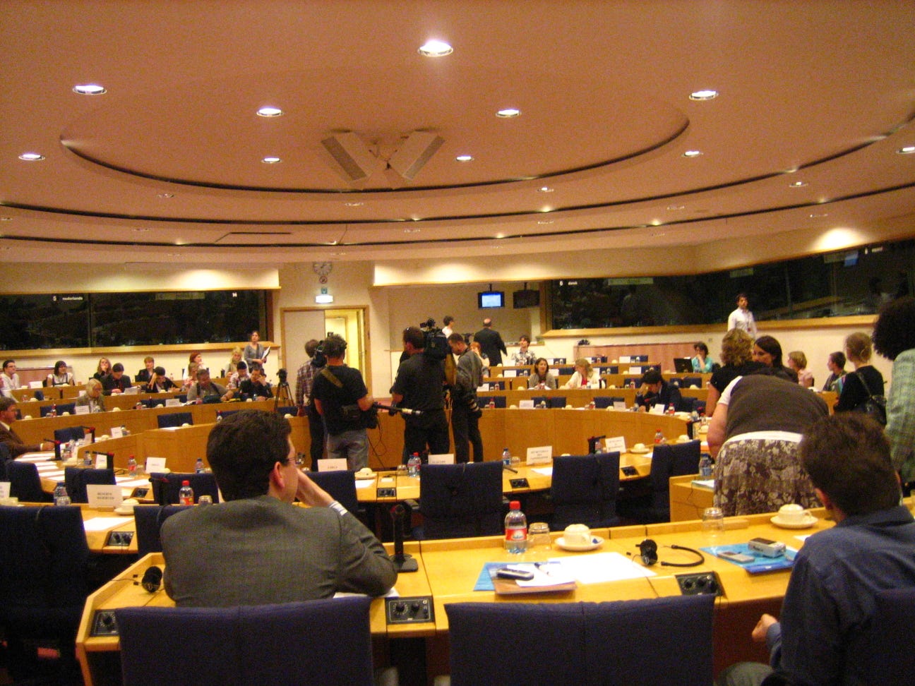 A committee room of the European Parliament in Brussels, rows of empty desks beneath a high ceiling. A committee room of the European Parliament in Brussels, rows of empty desks beneath a high ceiling.