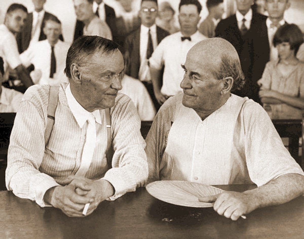 Clarence Darrow and William Jennings Bryan sitting next to each other and partly facing each other. Clarence Darrow and William Jennings Bryan sitting next to each other and partly facing each other.