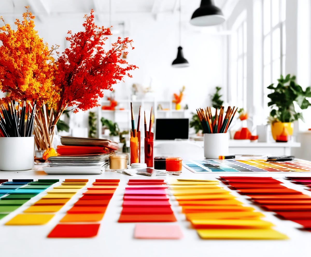 interior of an interior designers office with colourful paint chips laid out on a white table, plush design interiors adelaide
