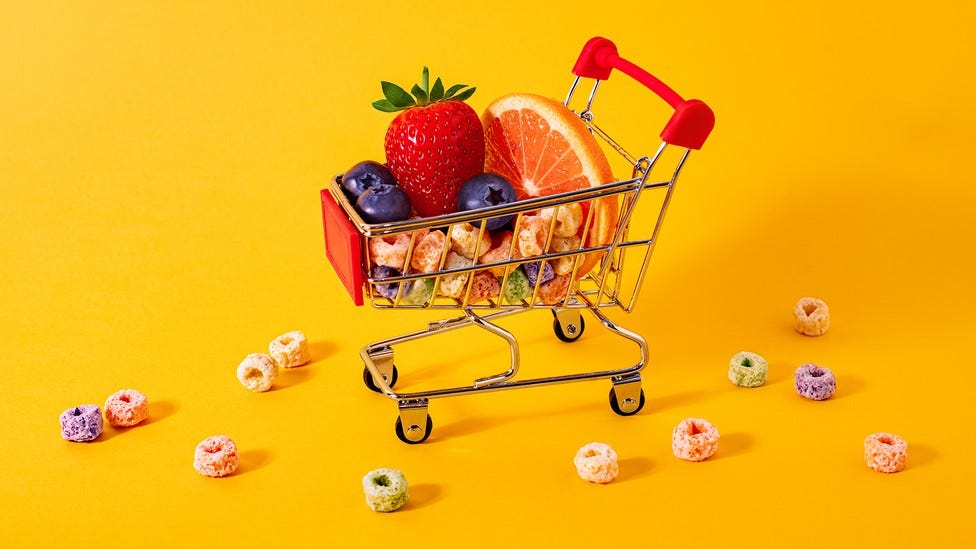 A miniature cart holding fruit slices and colorful cereal