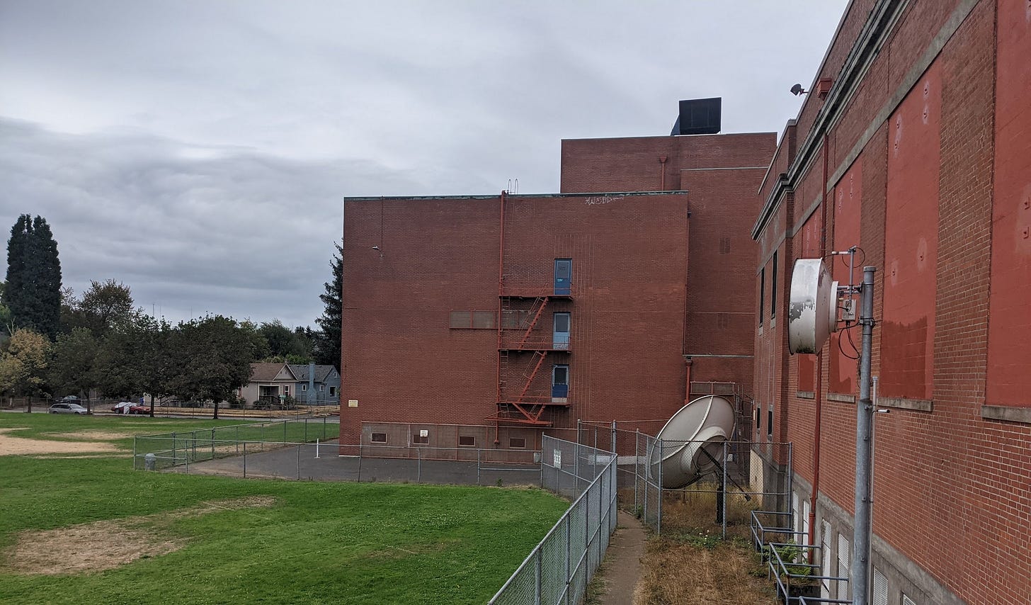 The rear face of Jefferson High School in Northeast Portland, Oregon.  A brick facade on a cloudy day.