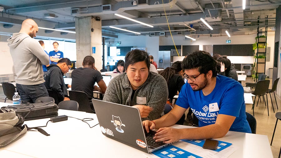 A facilitator helps a participant debug an issue. The success of Global Day of Coderetreat 2019 Toronto was thanks to our dedicated and experienced facilitators. A facilitator helps a participant debug an issue. The success of Global Day of Coderetreat 2019 Toronto was thanks to our dedicated and experienced facilitators.