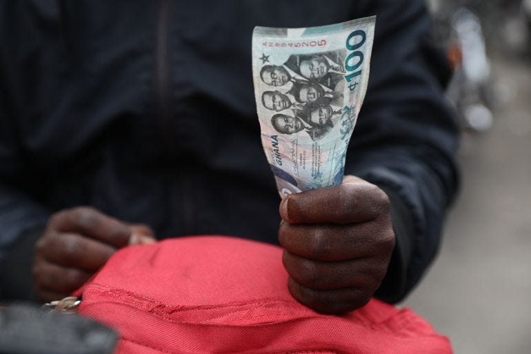 A man holds a 100 cedis, the Ghana currency, note in Accra A man holds a 100 cedis, the Ghana currency, note in Accra