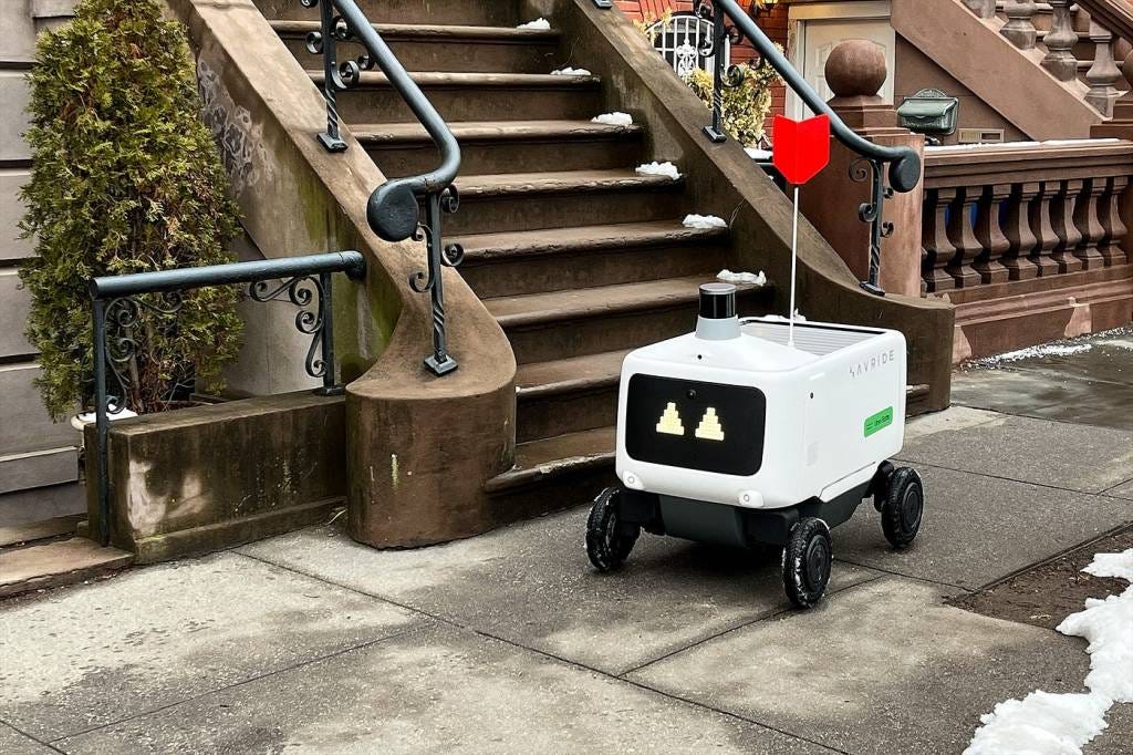An Avride autonomous robot on wheels delivering Uber Eats order in Jersey City, New Jersey.