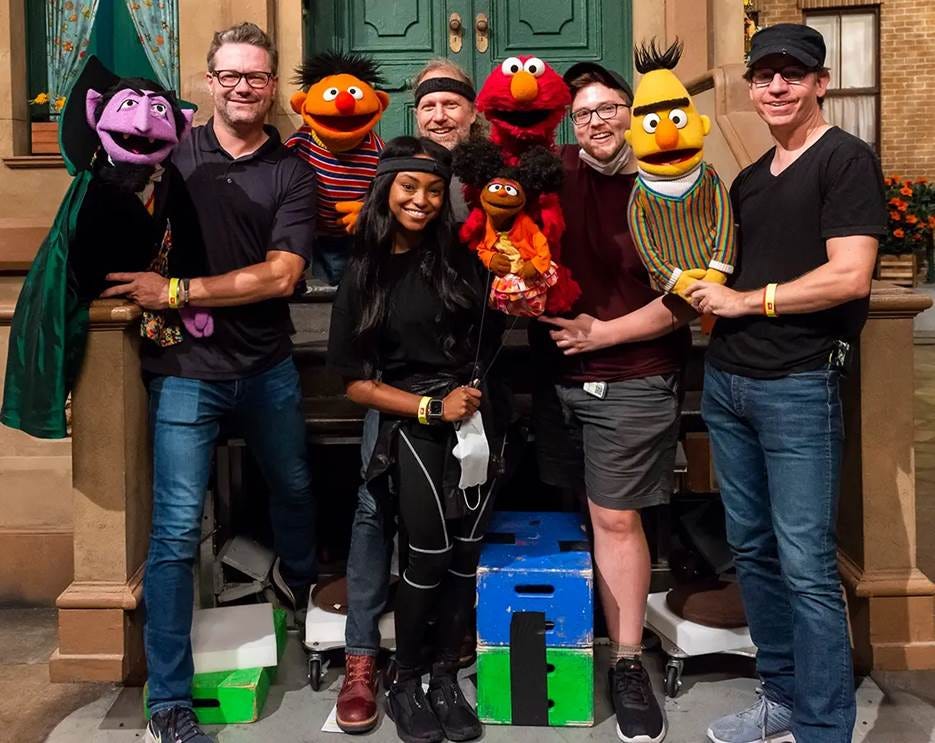 A group of people posing with puppets

AI-generated content may be incorrect.