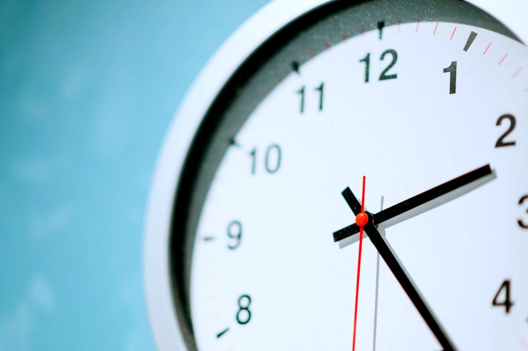 white round wall clock at 2:25 white round wall clock at 2:25