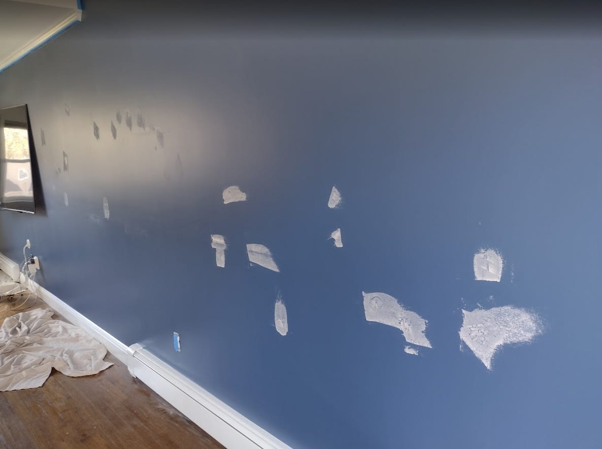 Spackling and sanding accent wall.