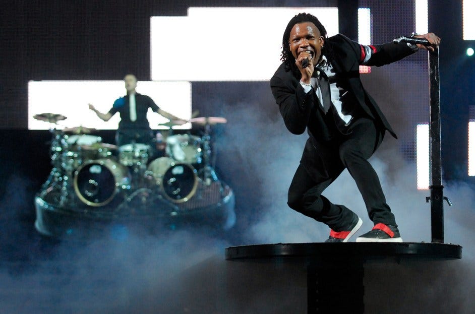 Michael Tait singing on stage with drummer in the background.